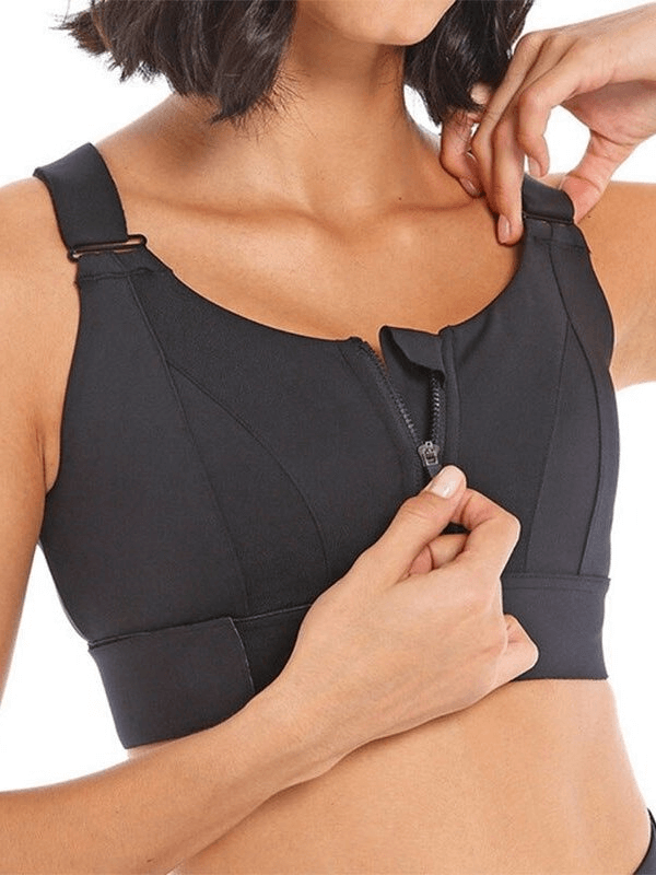 Woman wearing black shockproof sports bra with adjustable fastening, demonstrating its supportive fit and comfort for fitness.